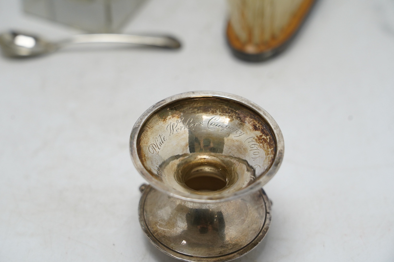 A George V silver miniature font, inscribed 'The Tin Plate Worker's Company', Lee & Wigful, Sheffield, 1924, 45mm, together with seven assorted silver condiments including George III silver mustard by Henry Chawner, a si